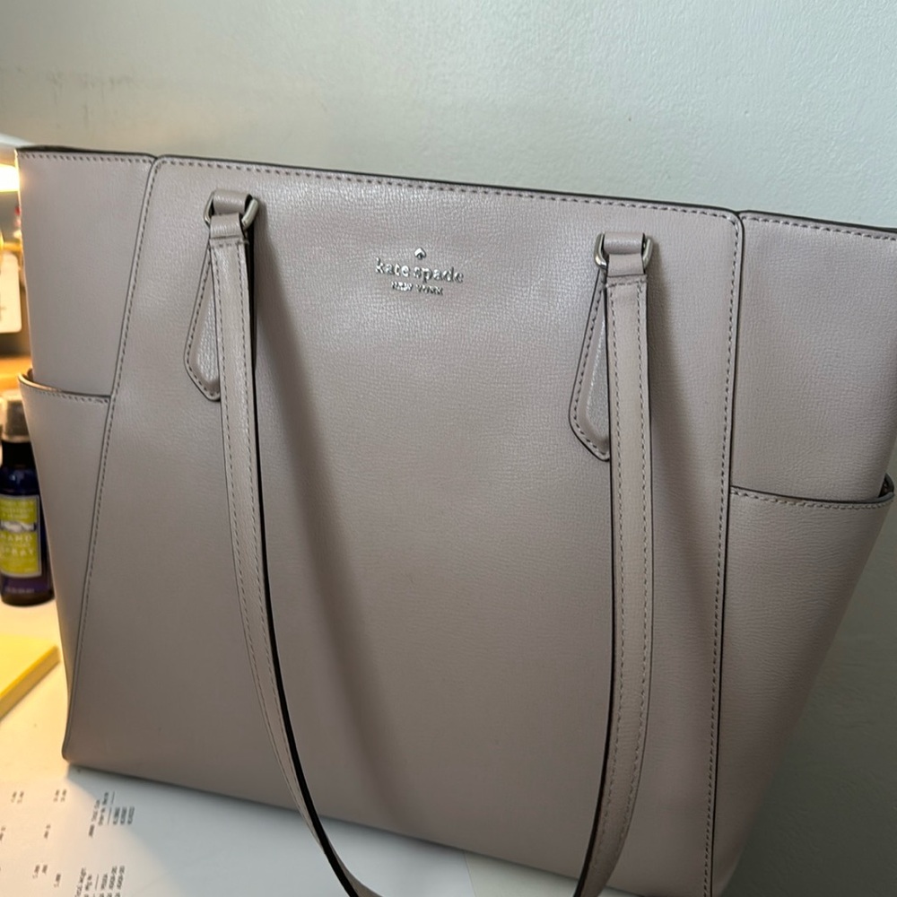 Kate spade cream colored bag used a handful of times. Like new.